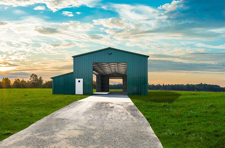 Custom steel warehouse with attached shed, lean-to and enclosed storage area. Large industrial doors.